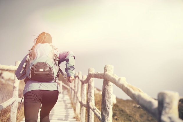 woman running on mountain stairs