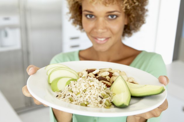 Mid Adult Woman Holding A Plate With Healthy Food