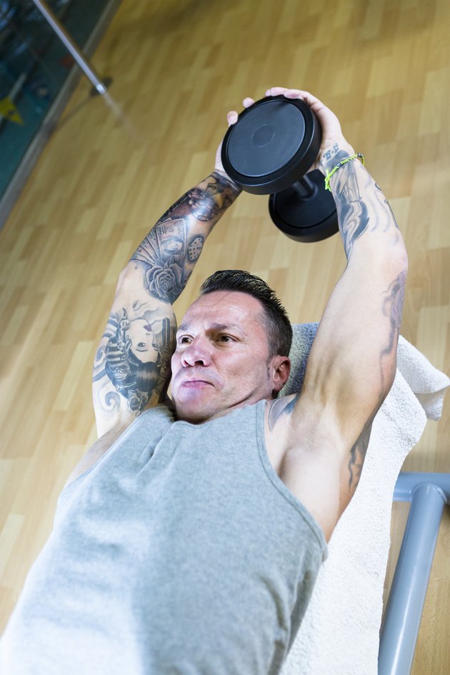 man making dumbbell pull overs - workout routine