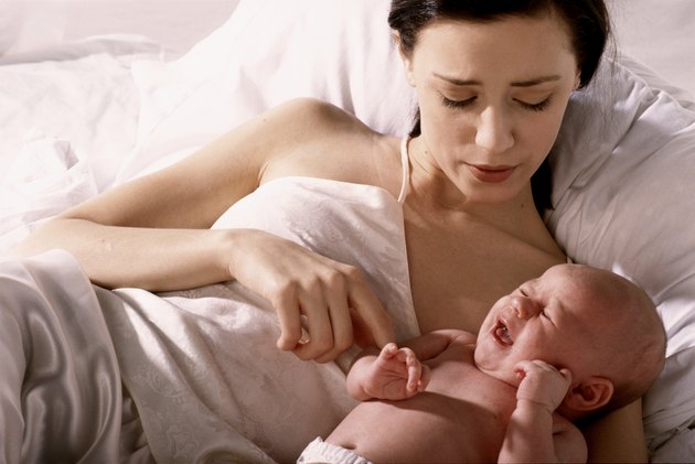 High angle view of a mother lying in bed with her son