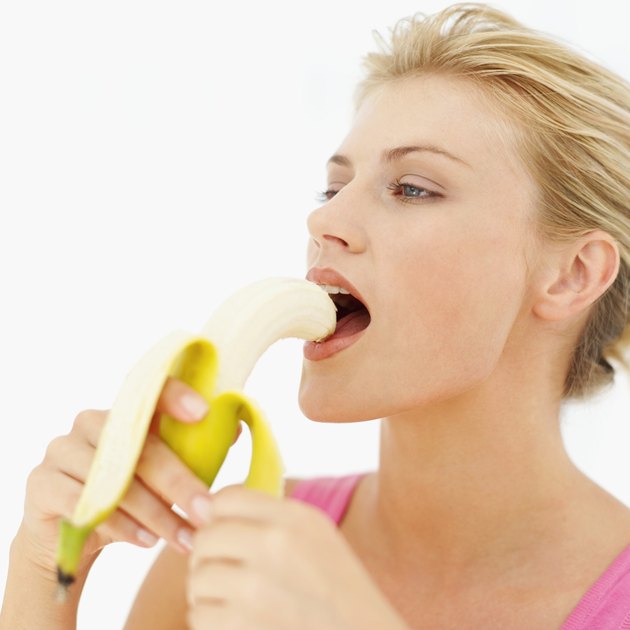 Young woman eating a banana