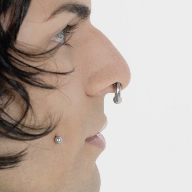 Side profile of a young man with piercing