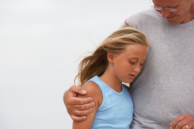 Man with arm round girl (10-11), waist up