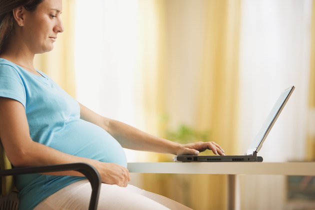Pregnant woman using a laptop