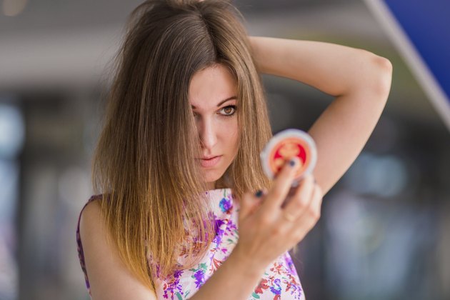 Young woman looking at mirror