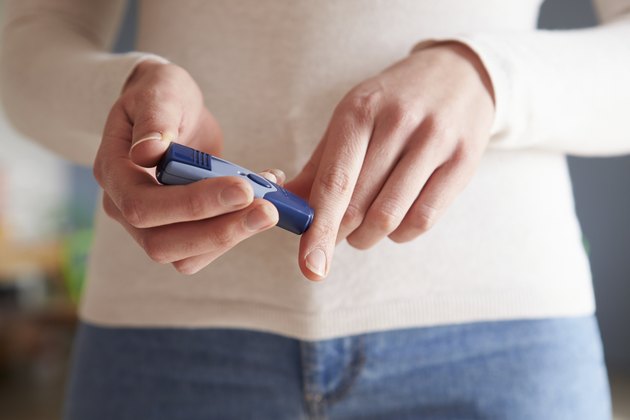 Female Diabetic Checking Blood Sugar Levels