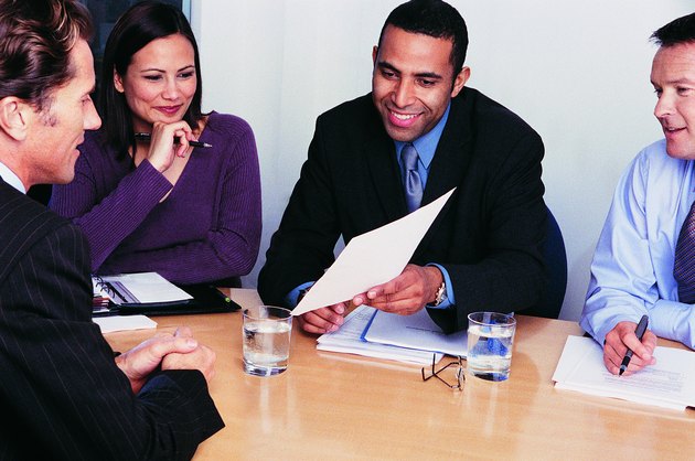 Three Business Colleagues Interviewing a Businessman