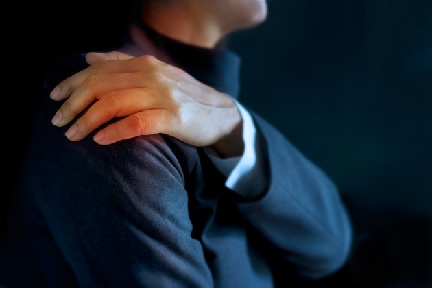 heavy shoulder pain of business woman colored in red
