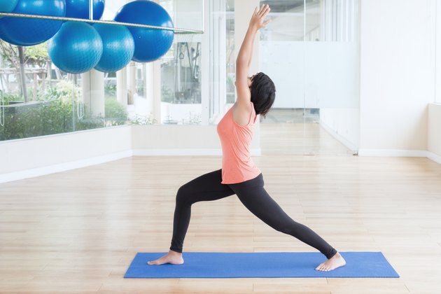 Asian woman make yoga Warrior pose