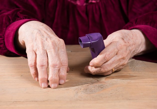 Woman's hands holding asthma inhaler