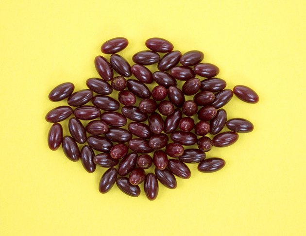 Cranberry capsules on yellow background
