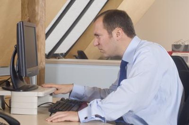 Businessman looking at a computer monitor