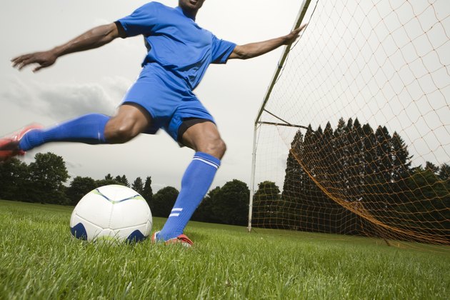Man kicking soccer ball