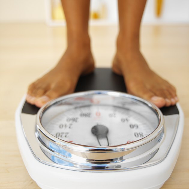 Close-up of a woman standing on a weighing scales
