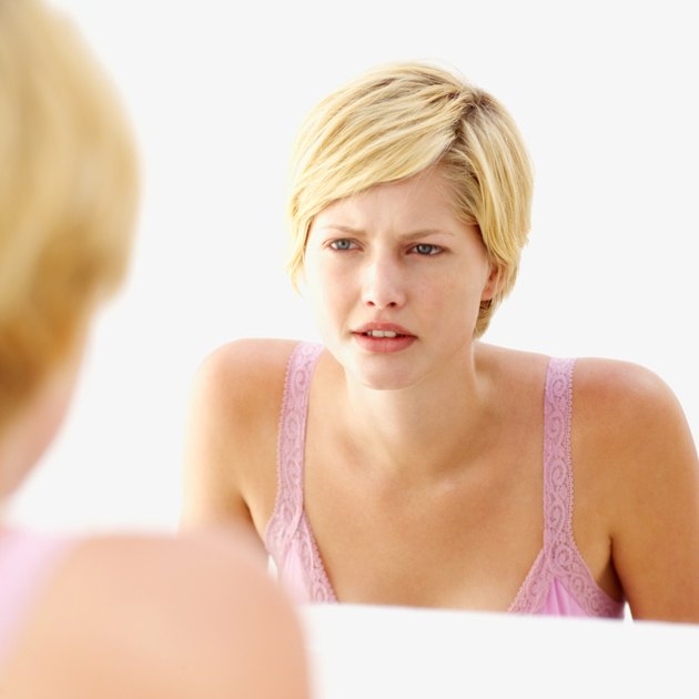 woman looking into a mirror