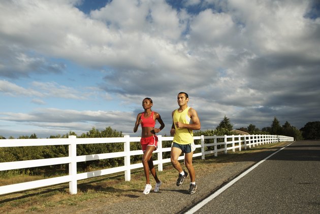 Man and woman jogging along country road