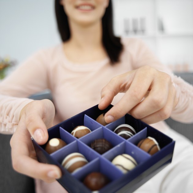 Woman enjoying a box of chocolates