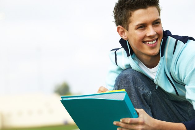 teenage boy (16 - 18) holding folder