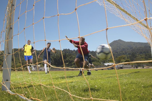 Group of young people playing soccer