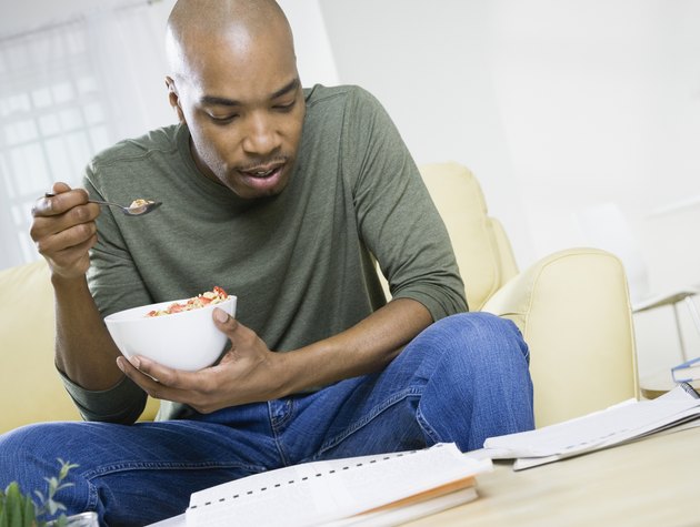 African American man eating cereal