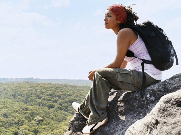 Woman Sitting on Rock Looking at View