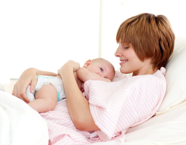 Patient and newborn baby in bed
