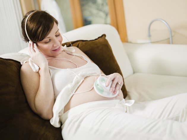 pregnant woman listening to her baby heartbeat