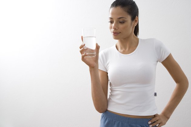 Young woman holding glass of water