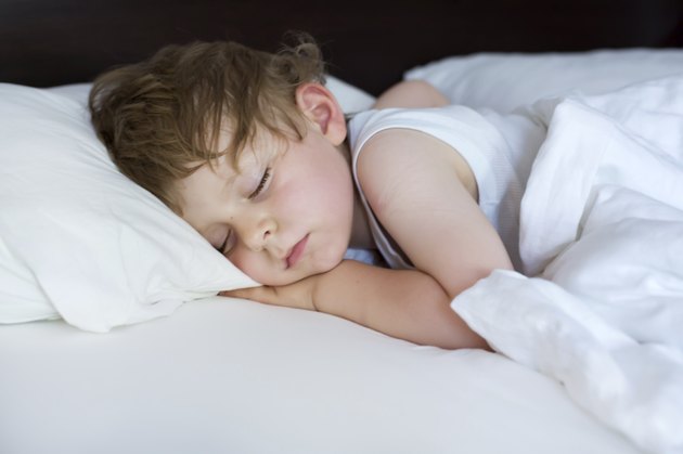 Little sweet toddler boy sleeping in his bed