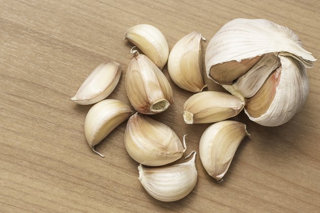 Dried garlic bulbs on a wooden table.