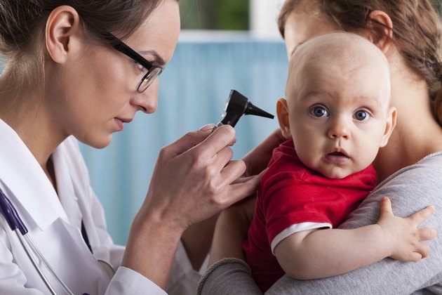 Child's otolaryngologist doing ear examination