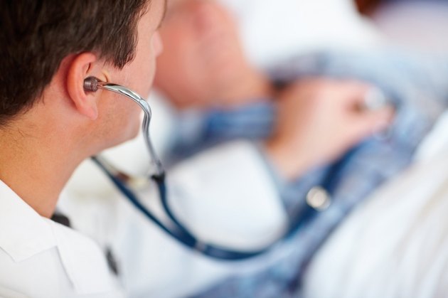 Doctor examining a patients heart beat with a stethoscope