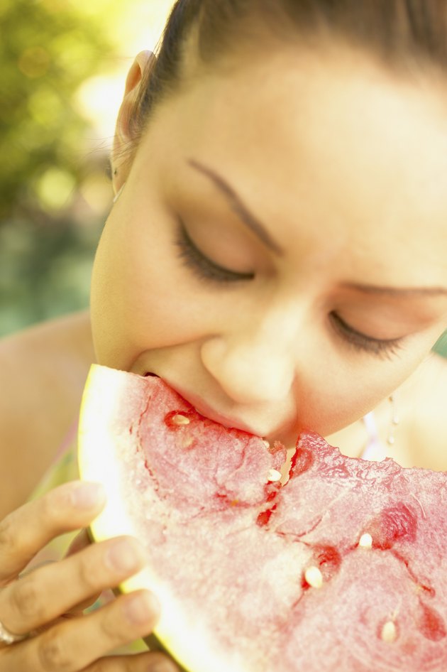 Young woman eating a watermelon slice