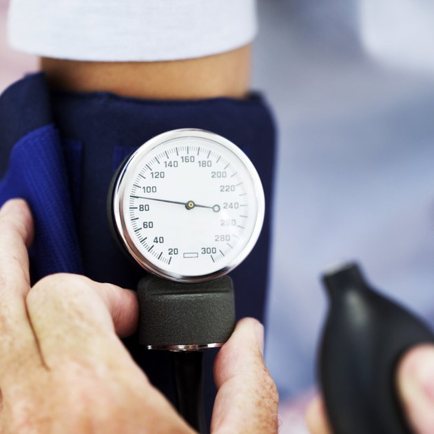medical personnel checking blood pressure