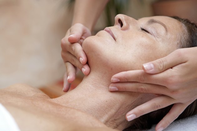 Mature woman receiving massage, eyes closed, close-up