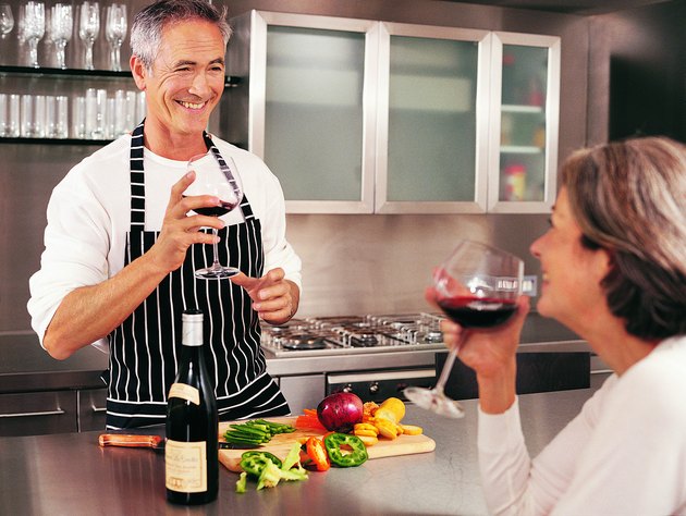 Mature Couple Drinking Wine in Their Kitchen