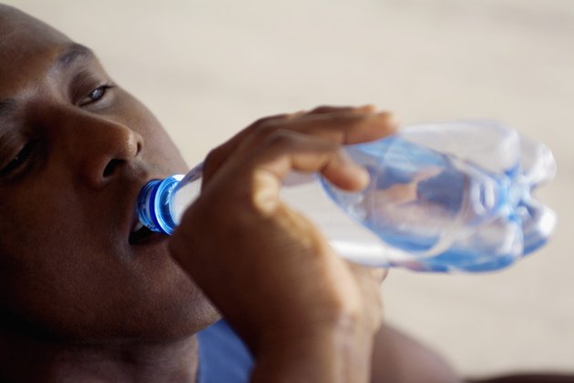 Man drinking bottled water, close-up