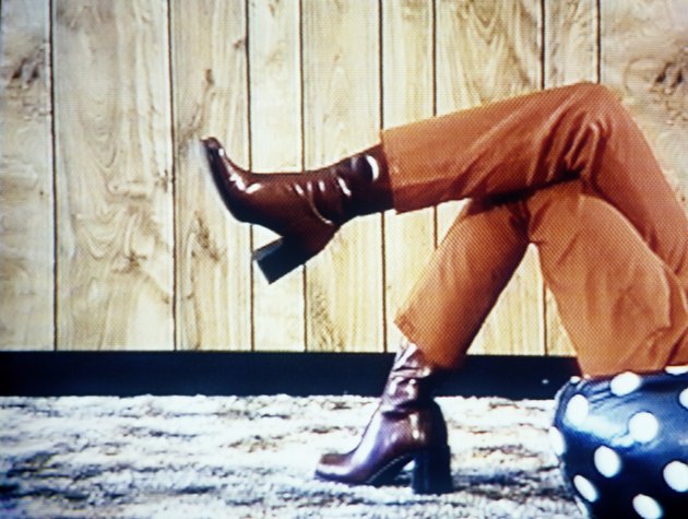 Young woman resting on bean bag chair, low section (video still)