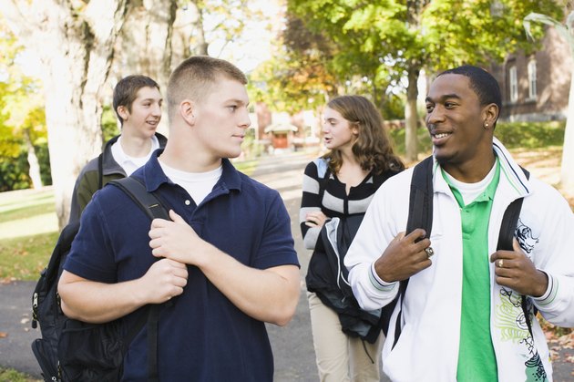 Four students smiling at each other
