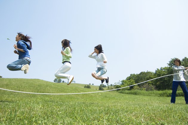 Four young people skipping