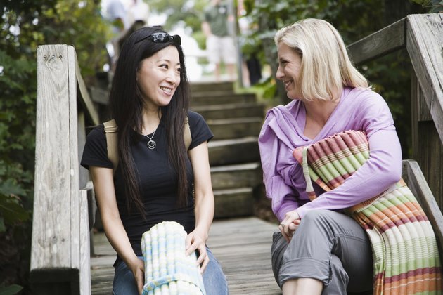 Two women sitting on a staircase and smiling