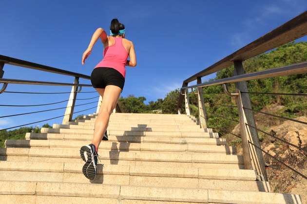 healthy lifestyle sports woman running up on stone stairs seaside