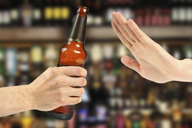 hand reject a bottle of beer