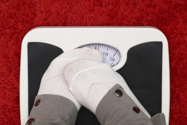 Female feet on bathroom scale
