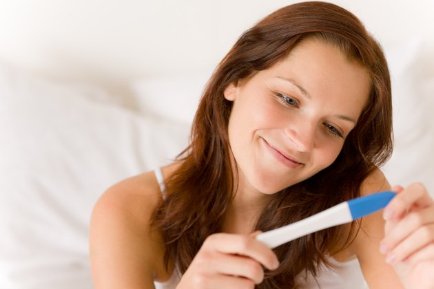 Pregnancy test - happy surprised woman