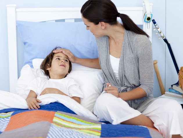 Mother taking her sons temperature