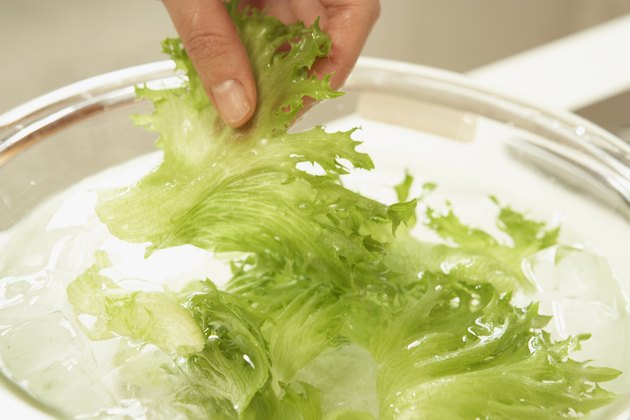 Woman making salad, close up