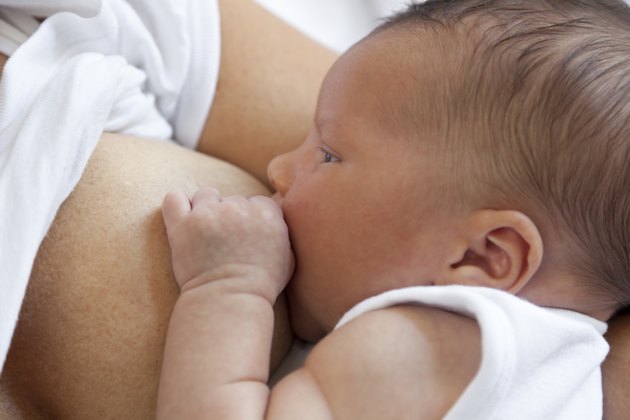 Newborn baby gets breastfeeding