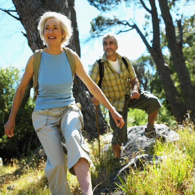 front view of mature man and mature woman walking in countryside