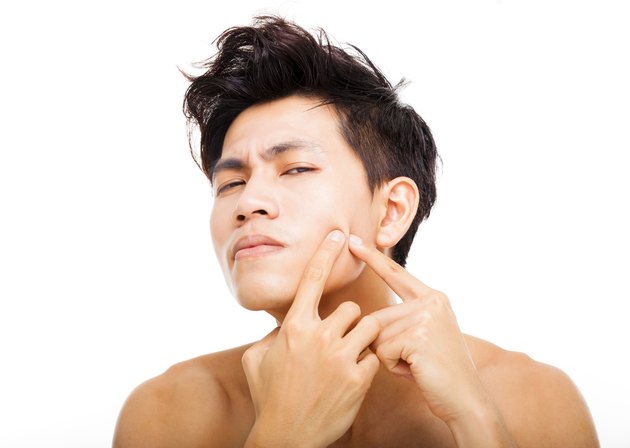 handsome young man Squeezing pimple